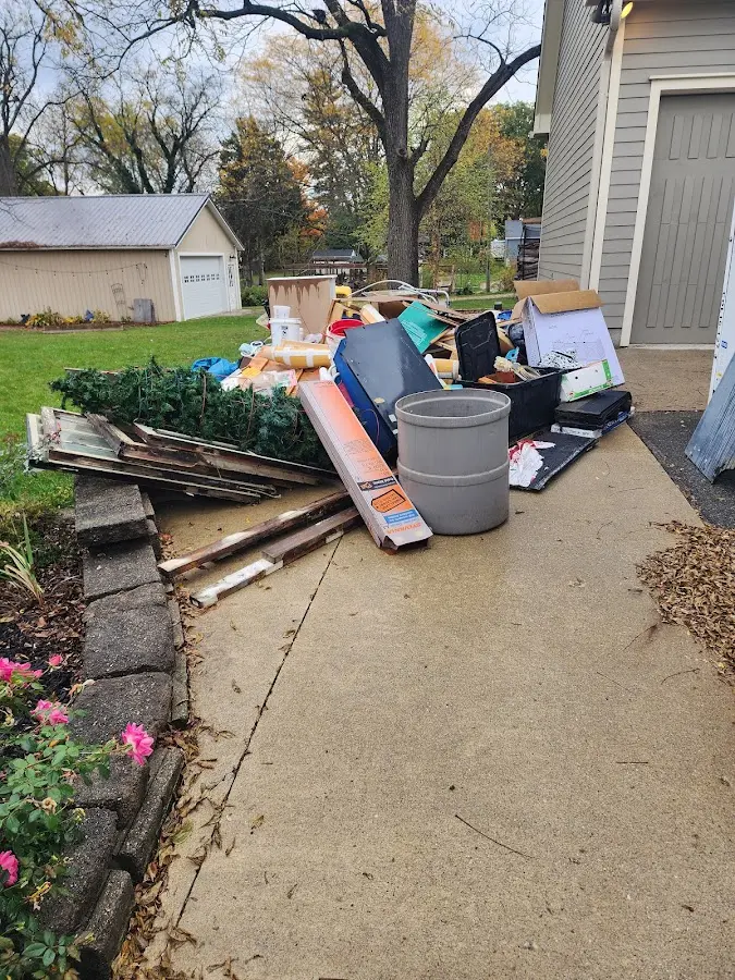 Dumpster being loaded with debris for Estate Cleanout Dumpster Rental in Elkins